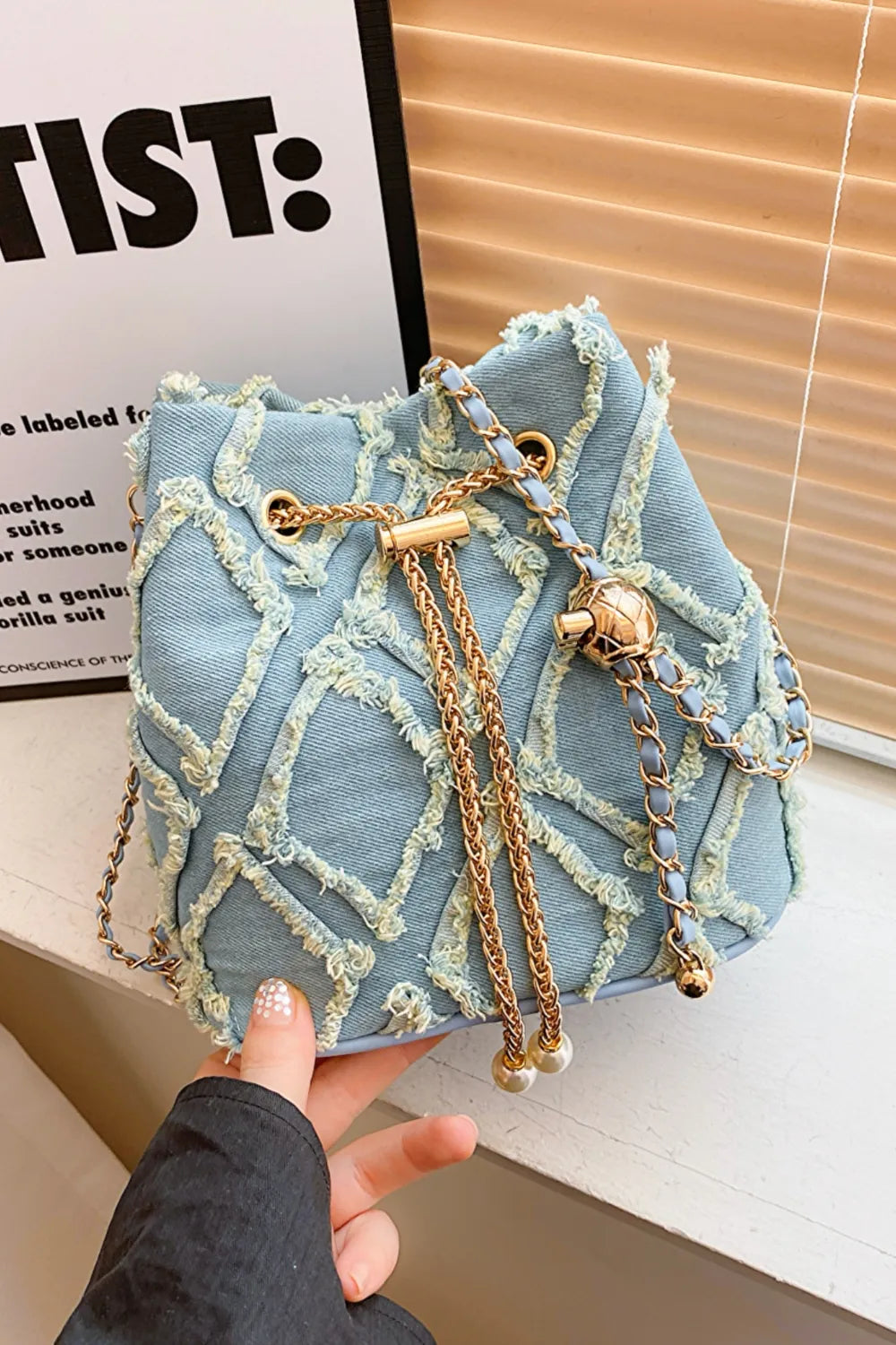 Chain Drawstring Raw Edge Denim Bucket Bag - Premium Crossbody Bag from Trendsi - Just $34.99! Shop now at Handbags Specialist Headquarter