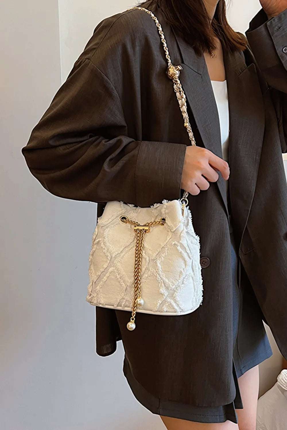 Chain Drawstring Raw Edge Denim Bucket Bag - Premium Crossbody Bag from Trendsi - Just $34.99! Shop now at Handbags Specialist Headquarter