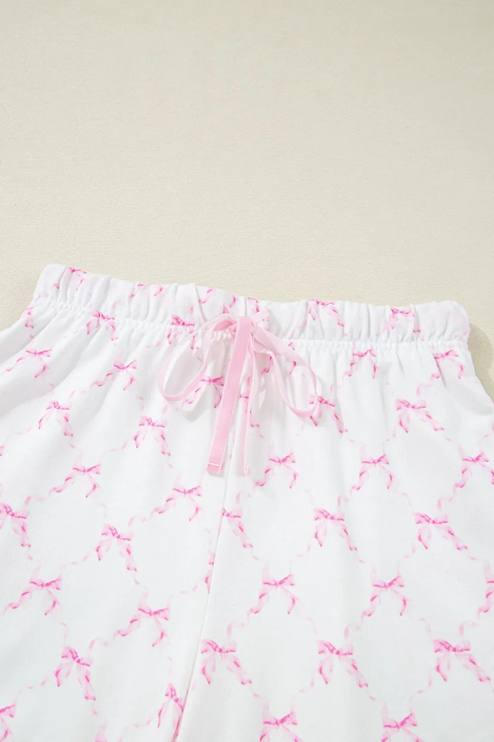 Bow Print Lettuce Trim Round Neck Top and Shorts Lounge Set - Premium Sleepwear from Trendsi - Just $32.14! Shop now at Handbags Specialist Headquarter