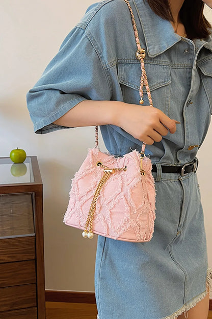 Chain Drawstring Raw Edge Denim Bucket Bag - Premium Crossbody Bag from Trendsi - Just $34.99! Shop now at Handbags Specialist Headquarter