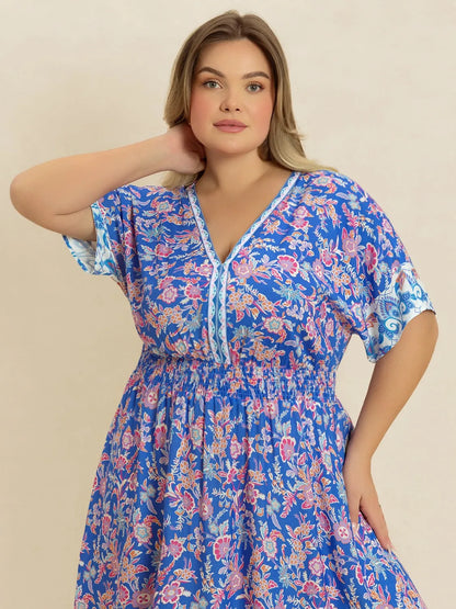 Plus Size Smocked Printed Half Sleeve Midi Dress - Premium Dresses from Trendsi - Just $43.99! Shop now at Handbags Specialist Headquarter