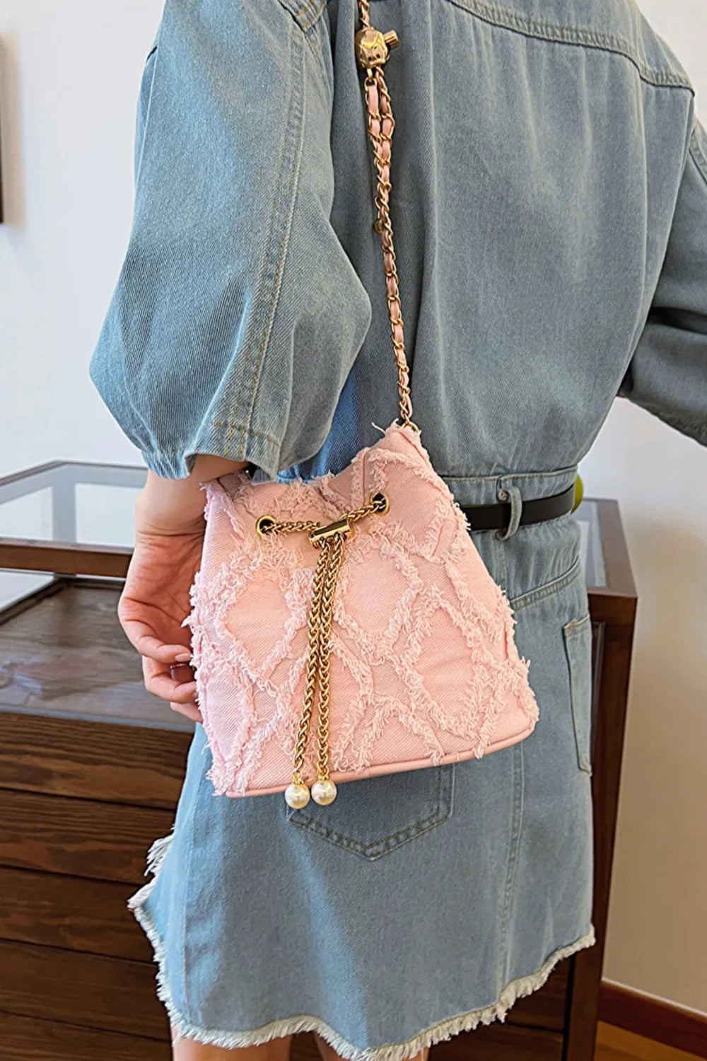 Chain Drawstring Raw Edge Denim Bucket Bag - Premium Crossbody Bag from Trendsi - Just $34.99! Shop now at Handbags Specialist Headquarter