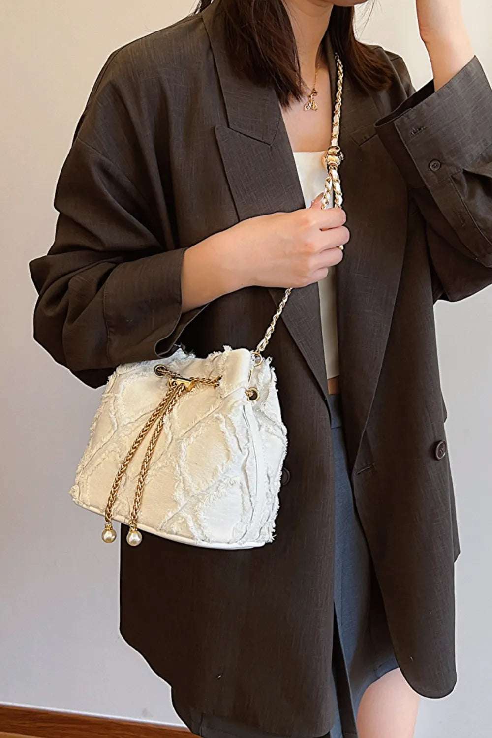 Chain Drawstring Raw Edge Denim Bucket Bag - Premium Crossbody Bag from Trendsi - Just $34.99! Shop now at Handbags Specialist Headquarter