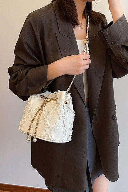 Chain Drawstring Raw Edge Denim Bucket Bag - Premium Crossbody Bag from Trendsi - Just $34.99! Shop now at Handbags Specialist Headquarter