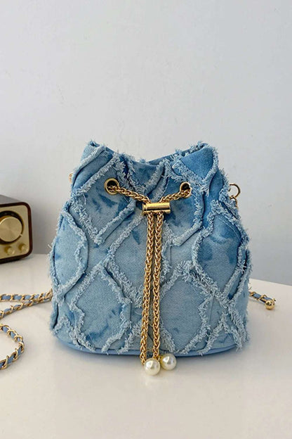 Chain Drawstring Raw Edge Denim Bucket Bag - Premium Crossbody Bag from Trendsi - Just $34.99! Shop now at Handbags Specialist Headquarter