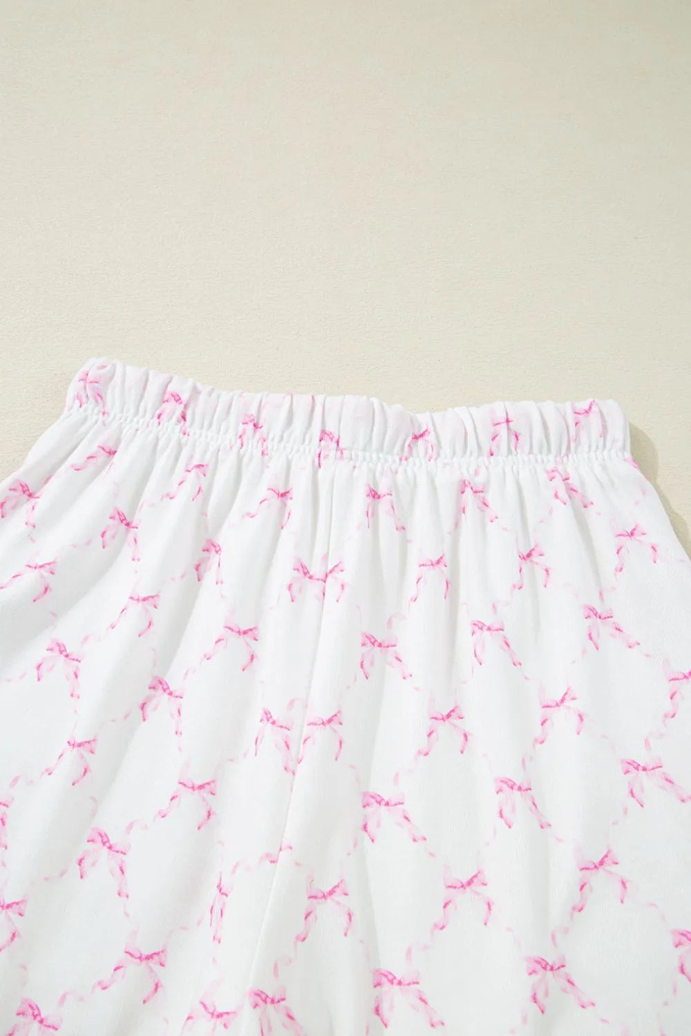 Bow Print Lettuce Trim Round Neck Top and Shorts Lounge Set - Premium Sleepwear from Trendsi - Just $32.14! Shop now at Handbags Specialist Headquarter