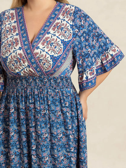 Plus Size Printed Surplice Half Sleeve Dress - Premium Dresses from Trendsi - Just $48.99! Shop now at Handbags Specialist Headquarter