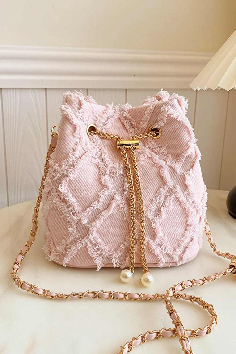 Chain Drawstring Raw Edge Denim Bucket Bag - Premium Crossbody Bag from Trendsi - Just $34.99! Shop now at Handbags Specialist Headquarter