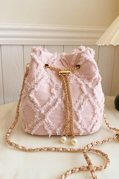 Chain Drawstring Raw Edge Denim Bucket Bag - Premium Crossbody Bag from Trendsi - Just $34.99! Shop now at Handbags Specialist Headquarter