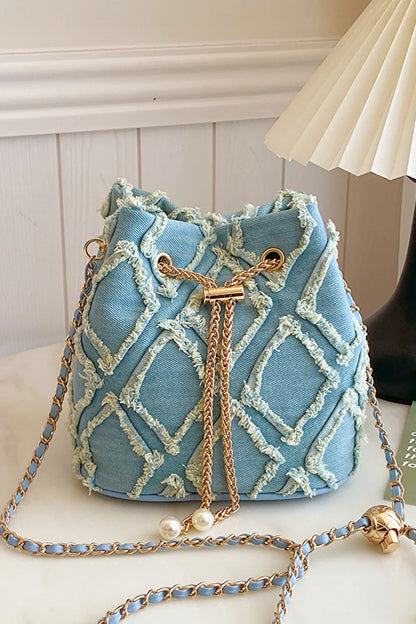 Chain Drawstring Raw Edge Denim Bucket Bag - Premium Crossbody Bag from Trendsi - Just $34.99! Shop now at Handbags Specialist Headquarter
