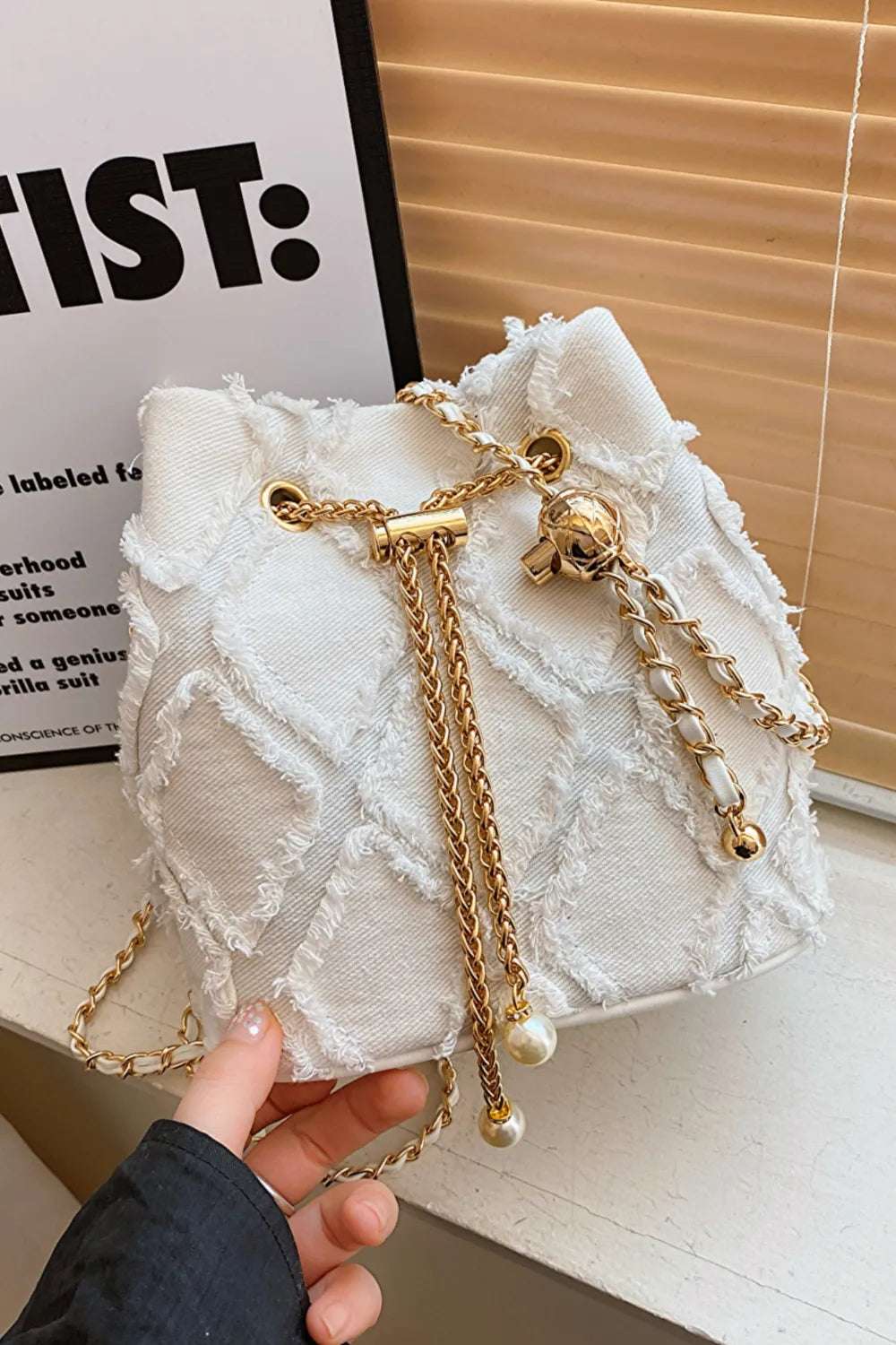 Chain Drawstring Raw Edge Denim Bucket Bag - Premium Crossbody Bag from Trendsi - Just $34.99! Shop now at Handbags Specialist Headquarter