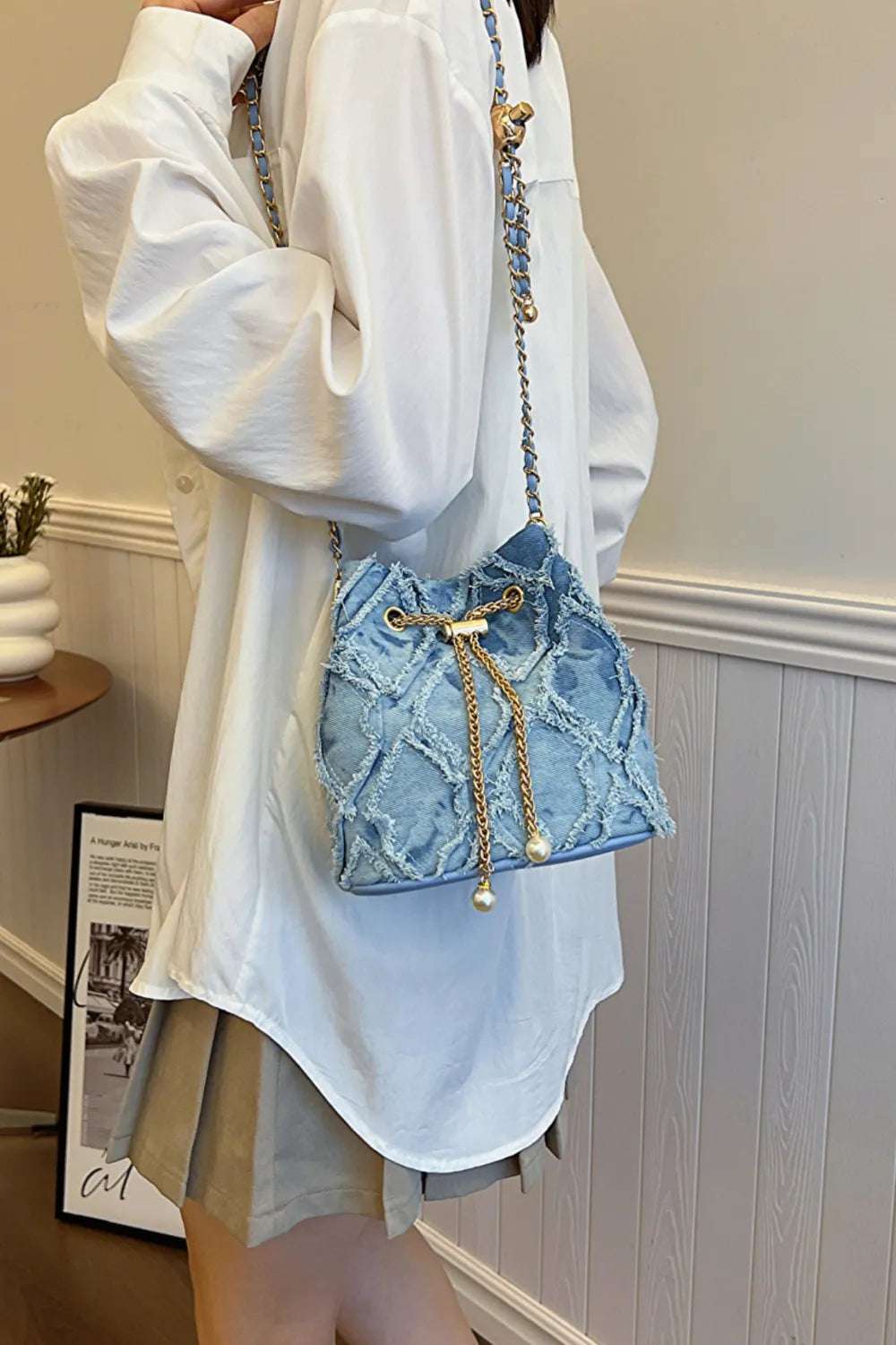 Chain Drawstring Raw Edge Denim Bucket Bag - Premium Crossbody Bag from Trendsi - Just $34.99! Shop now at Handbags Specialist Headquarter