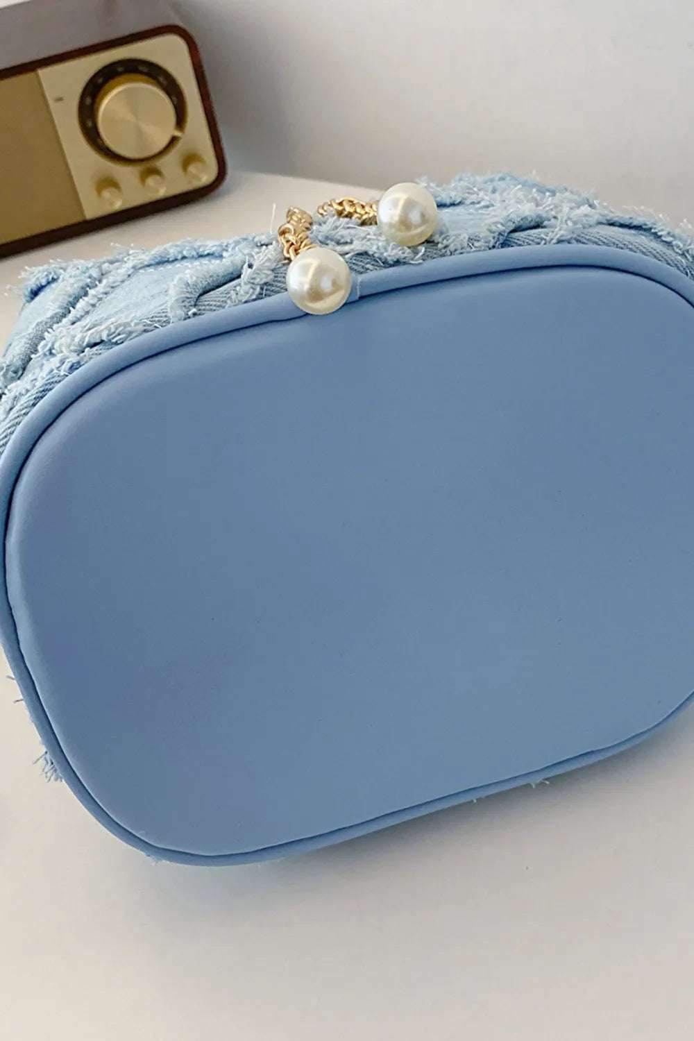 Chain Drawstring Raw Edge Denim Bucket Bag - Premium Crossbody Bag from Trendsi - Just $34.99! Shop now at Handbags Specialist Headquarter