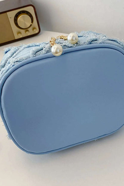 Chain Drawstring Raw Edge Denim Bucket Bag - Premium Crossbody Bag from Trendsi - Just $34.99! Shop now at Handbags Specialist Headquarter