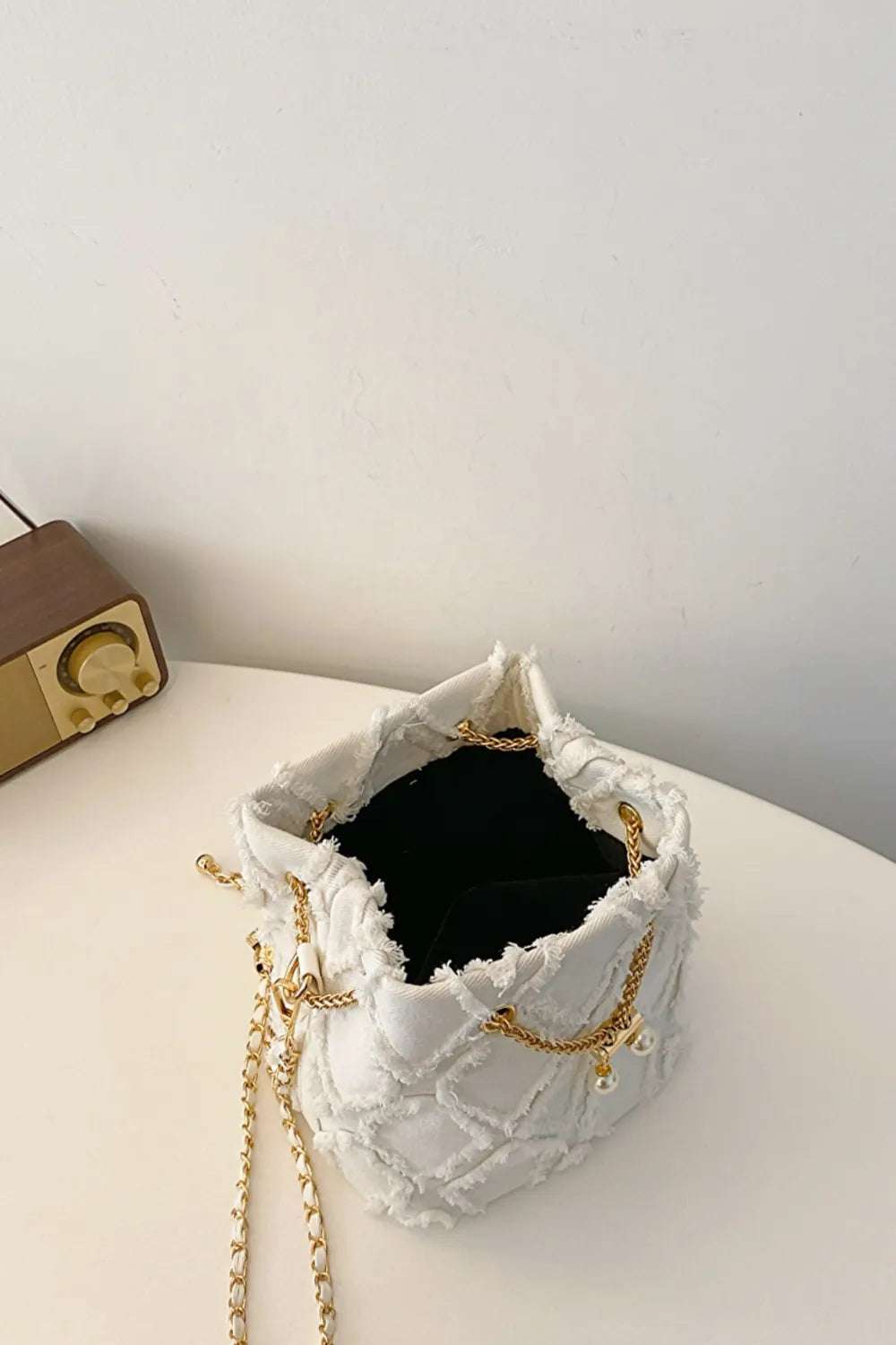 Chain Drawstring Raw Edge Denim Bucket Bag - Premium Crossbody Bag from Trendsi - Just $34.99! Shop now at Handbags Specialist Headquarter