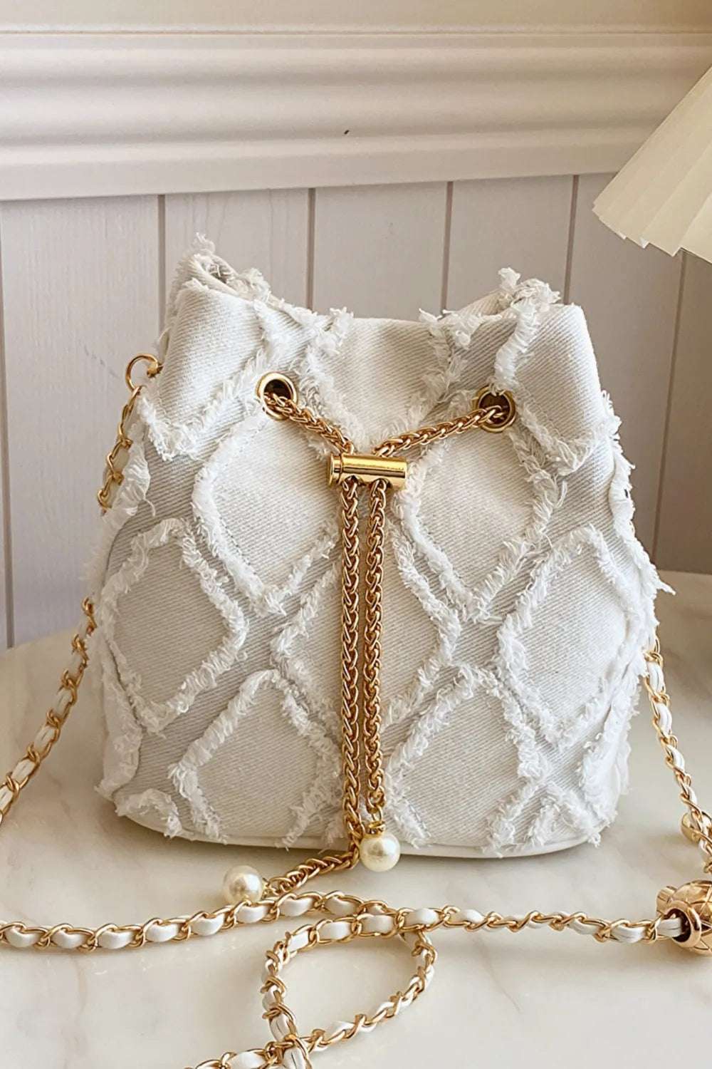 Chain Drawstring Raw Edge Denim Bucket Bag - Premium Crossbody Bag from Trendsi - Just $34.99! Shop now at Handbags Specialist Headquarter