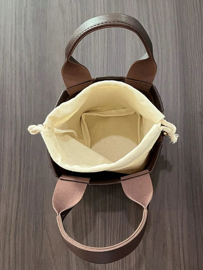 PU Leather Braided Bucket Bag - Premium Tote Bag from Trendsi - Just $33.99! Shop now at Handbags Specialist Headquarter
