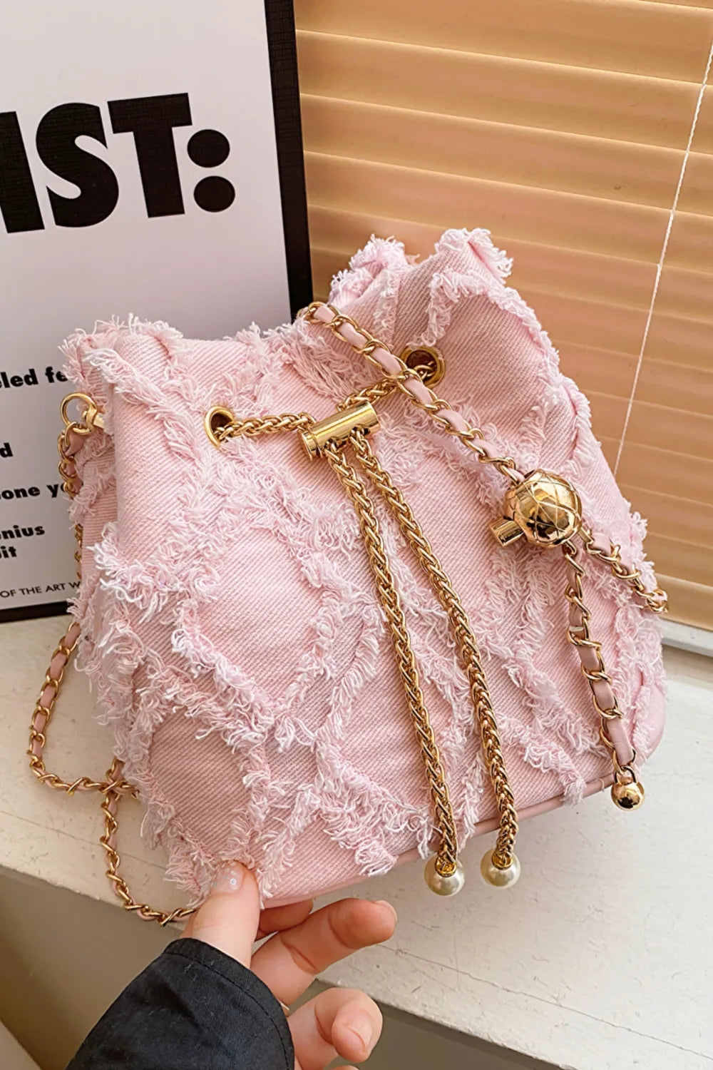 Chain Drawstring Raw Edge Denim Bucket Bag - Premium Crossbody Bag from Trendsi - Just $34.99! Shop now at Handbags Specialist Headquarter