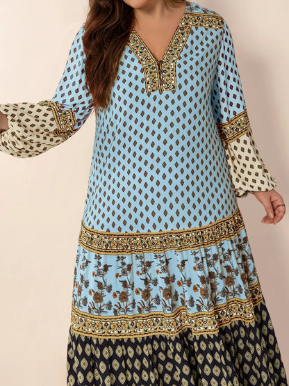 Plus Size Printed V-Neck Balloon Sleeve Maxi Dress - Premium Dresses from Trendsi - Just $52.99! Shop now at Handbags Specialist Headquarter