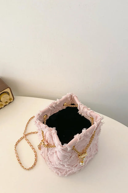 Chain Drawstring Raw Edge Denim Bucket Bag - Premium Crossbody Bag from Trendsi - Just $34.99! Shop now at Handbags Specialist Headquarter