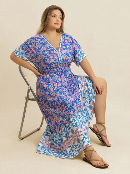 Plus Size Smocked Printed Half Sleeve Midi Dress - Premium Dresses from Trendsi - Just $43.99! Shop now at Handbags Specialist Headquarter