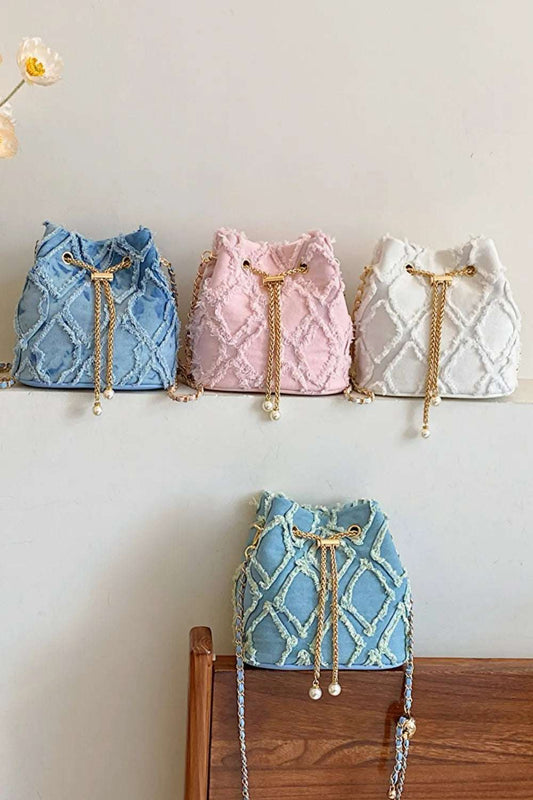 Chain Drawstring Raw Edge Denim Bucket Bag - Premium Crossbody Bag from Trendsi - Just $34.99! Shop now at Handbags Specialist Headquarter