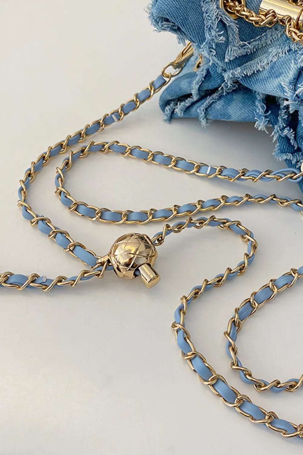 Chain Drawstring Raw Edge Denim Bucket Bag - Premium Crossbody Bag from Trendsi - Just $34.99! Shop now at Handbags Specialist Headquarter